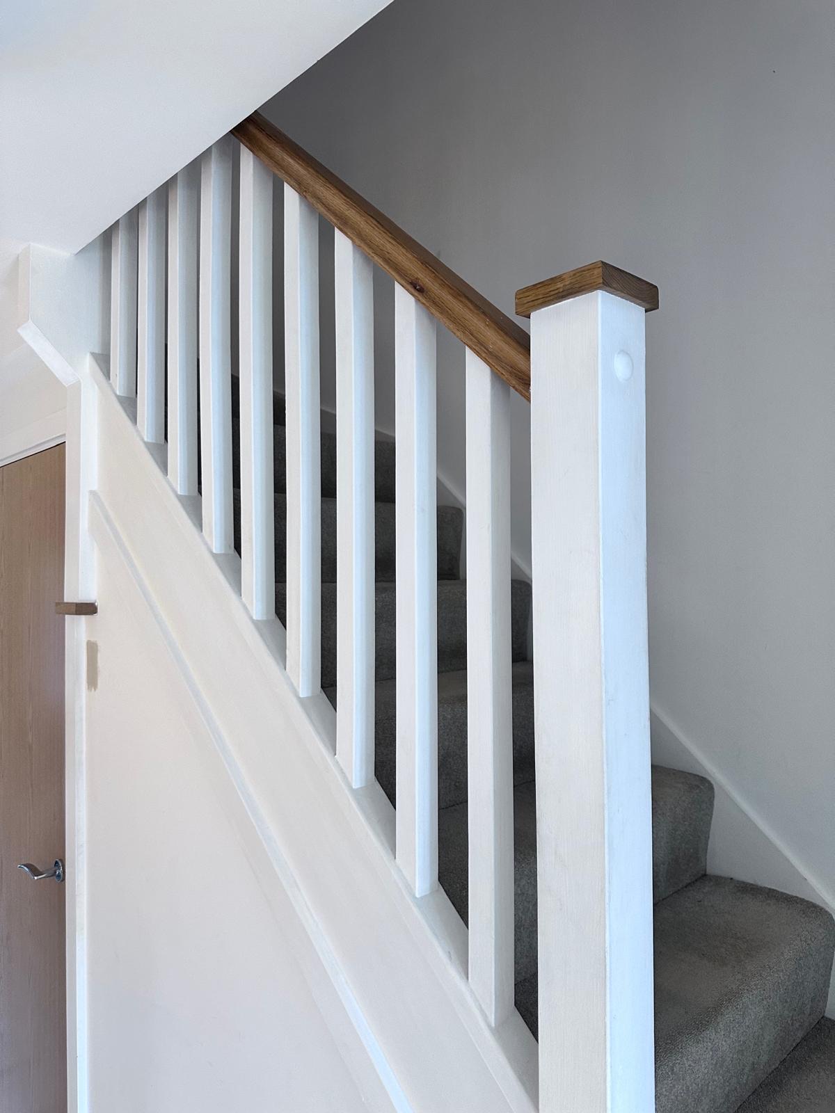 Staircase before renovation, with a painted timber spindle balustrade