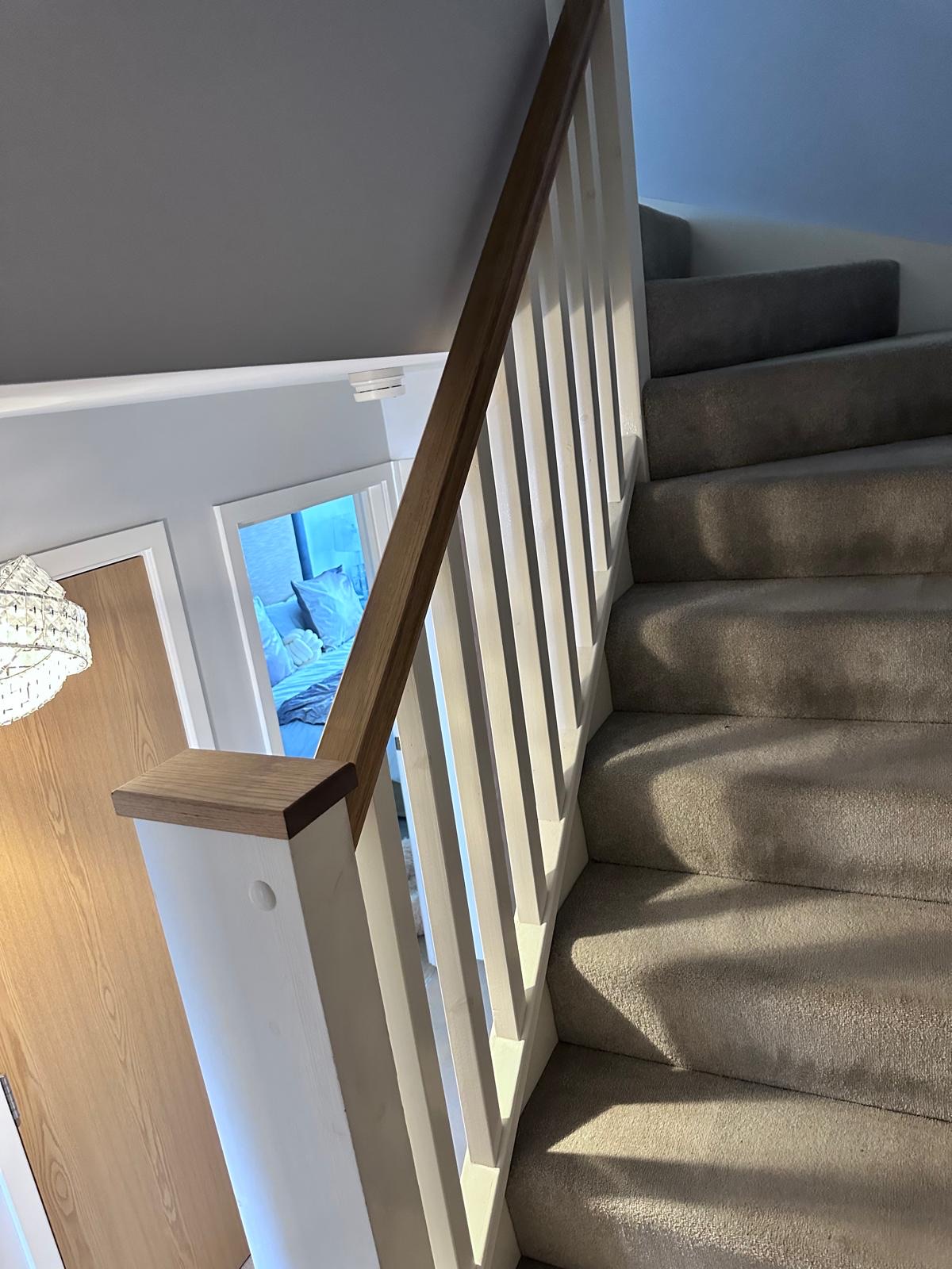 Landing and staircase before renovation, with timber spindles